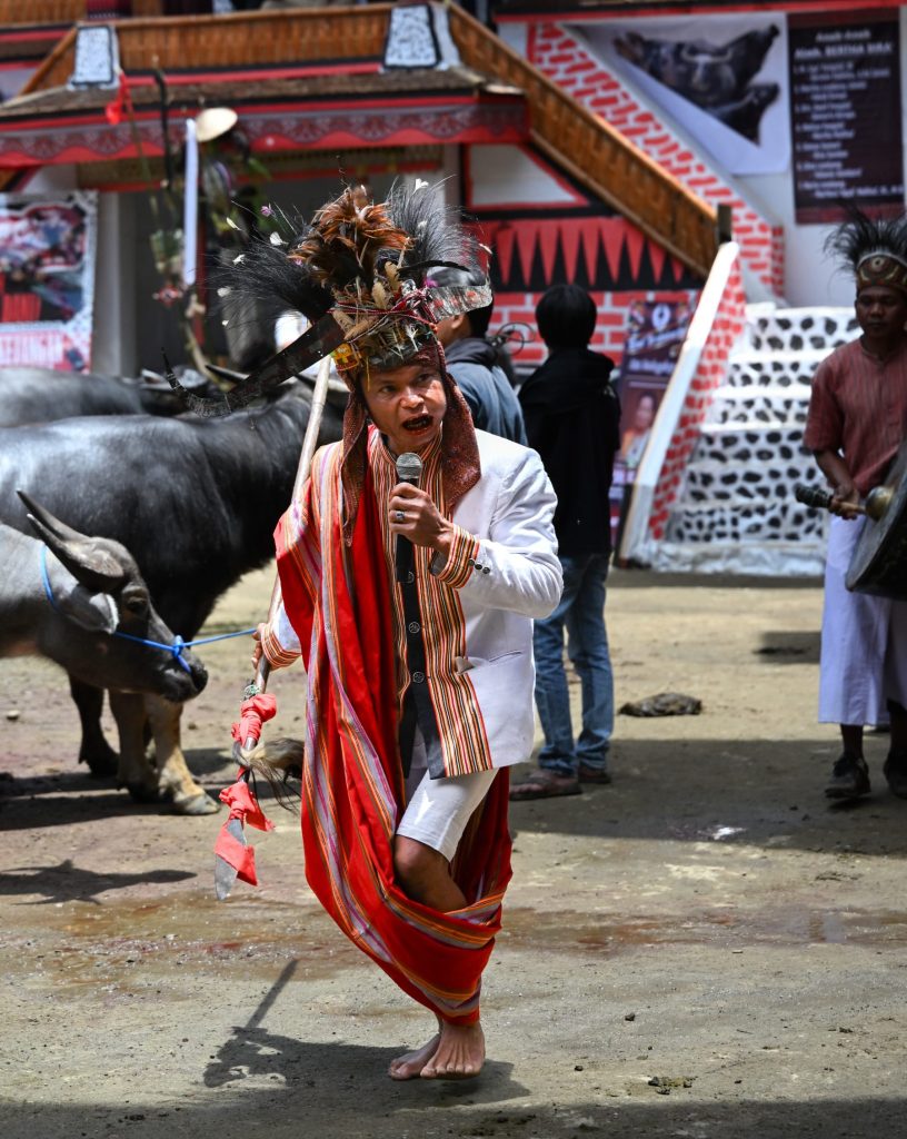 ceremonial chanting figure Rambu Solo funeral Tana Toraja Indonesia
